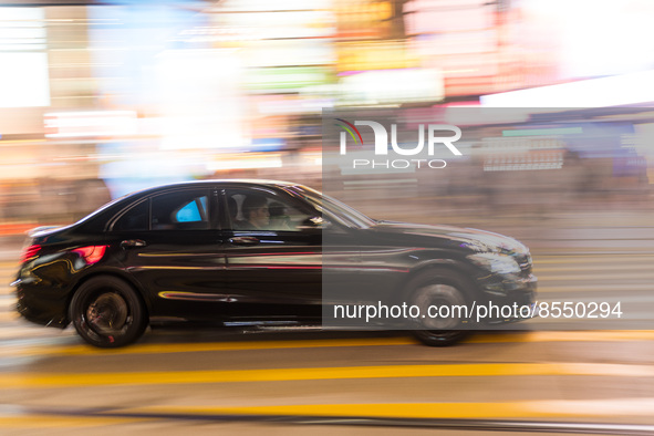 Hong Kong, China, 15 Jul 2022, A Mercedes Benz passes in Causeway Bay in a panned shot. 