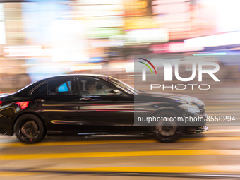 Hong Kong, China, 15 Jul 2022, A Mercedes Benz passes in Causeway Bay in a panned shot. (