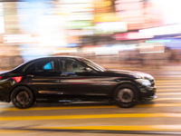 Hong Kong, China, 15 Jul 2022, A Mercedes Benz passes in Causeway Bay in a panned shot. (