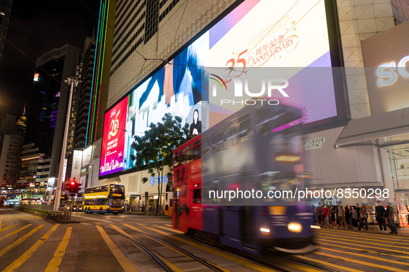 Hong Kong, China, 15 Jul 2022, A tramway passes in Causeway Bay in front of an electronic billboard celebrating the 25th anniversary of the...