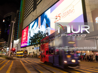 Hong Kong, China, 15 Jul 2022, A tramway passes in Causeway Bay in front of an electronic billboard celebrating the 25th anniversary of the...