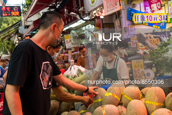 Hong Kong, China, 16 Jul 2022, Customers check melons at a fruit shop in Yuen Long. 