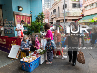 Hong Kong, China, 16 Jul 2022, Customers buy vegetables from small roadside stalls held by elderlies in Yuen Long.. (