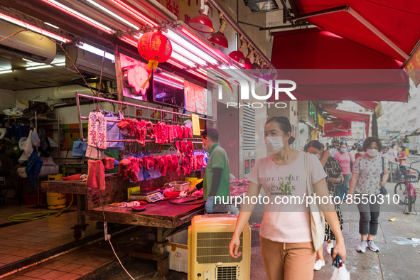 Hong Kong, China, 16 Jul 2022, Customers pass in front of a meat stall in Yuen Long. 