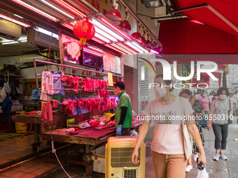 Hong Kong, China, 16 Jul 2022, Customers pass in front of a meat stall in Yuen Long. (