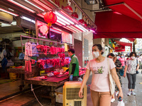 Hong Kong, China, 16 Jul 2022, Customers pass in front of a meat stall in Yuen Long. (