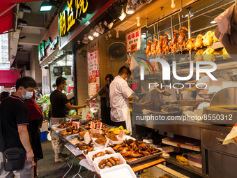 Hong Kong, China, 16 Jul 2022, Customers buy roast goose or chicken at a shop in Yuen Long. (