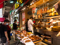 Hong Kong, China, 16 Jul 2022, Customers buy roast goose or chicken at a shop in Yuen Long. (