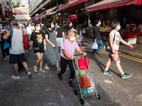 Hong Kong, China, 16 Jul 2022, People walk in a pedestrian street in Yuen Long. (