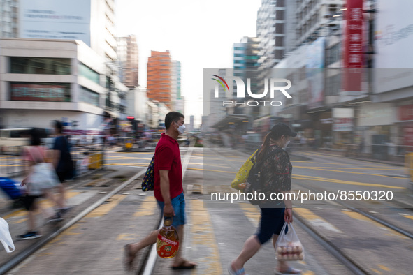 Hong Kong, China, 16 Jul 2022, People cross Castle Peak road in Yuen Long. 