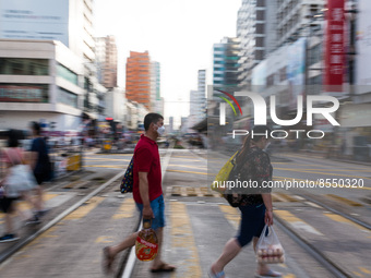 Hong Kong, China, 16 Jul 2022, People cross Castle Peak road in Yuen Long. (