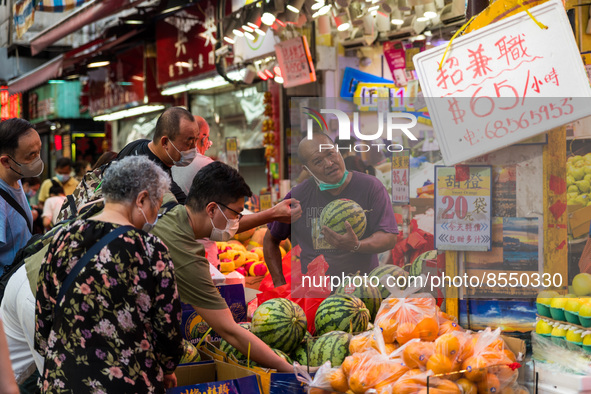 Hong Kong, China, 16 Jul 2022, Customers press around a fruit shop in Yuen Long, to buy watermelons. 