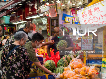 Hong Kong, China, 16 Jul 2022, Customers press around a fruit shop in Yuen Long, to buy watermelons. (