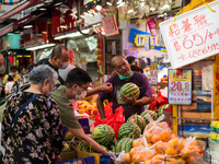 Hong Kong, China, 16 Jul 2022, Customers press around a fruit shop in Yuen Long, to buy watermelons. (