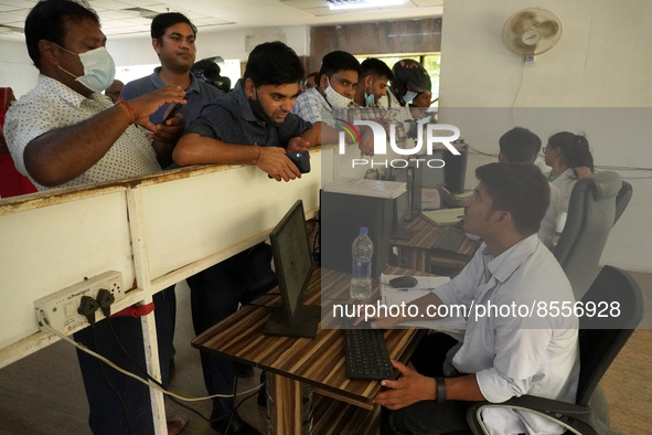 People register themselves to receive a dose during a vaccination drive against coronavirus, at a hospital in Noida on the outskirts of New...