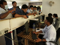 People register themselves to receive a dose during a vaccination drive against coronavirus, at a hospital in Noida on the outskirts of New...