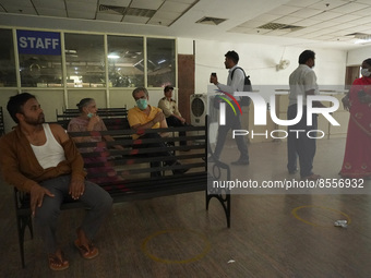 People wait at an observation area after receiving a dose during a vaccination drive against coronavirus, at a hospital in Noida on the outs...