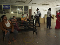 People wait at an observation area after receiving a dose during a vaccination drive against coronavirus, at a hospital in Noida on the outs...