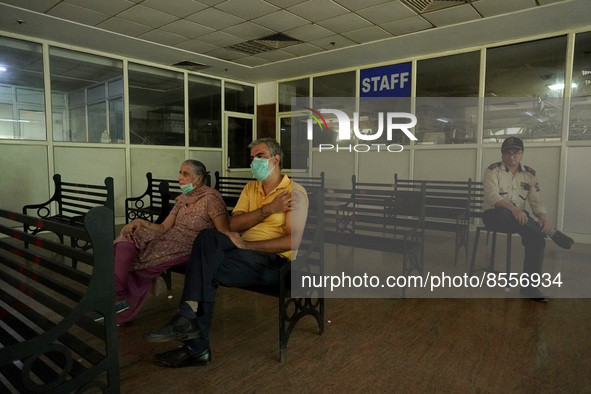 An elderly couple waits at an observation area after receiving a dose during a vaccination drive against coronavirus, at a hospital in Noida...