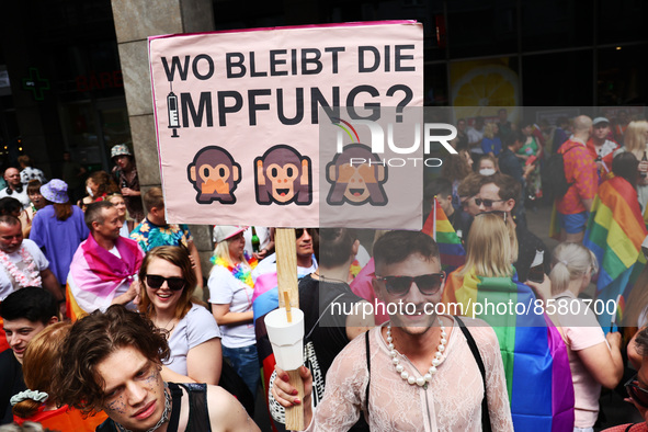 A man holds a banner reading 'Where is the vaccination?' during the Christopher Street Day demonstration in Berlin, Germany on July 23, 2022...