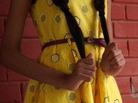 A young girl shows her locks of hair before being donated to cancer patients during 'Hair for Hope-India's donation drive held as part of an...