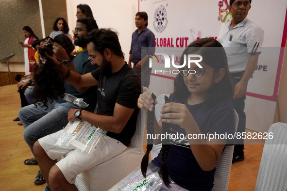 Volunteers show their locks of hair donated to cancer patients during 'Hair for Hope-India's donation drive held as part of an awareness cam...