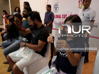 Volunteers show their locks of hair donated to cancer patients during 'Hair for Hope-India's donation drive held as part of an awareness cam...