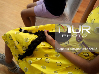 A young girl holds her locks of hair after snipping off for donating to cancer patients during 'Hair for Hope-India' donation drive held as...