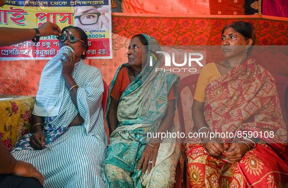 An ophthalmologist checks the eyes of a woman during a free eye-testing camp at Kumirmari village, in the Sundarbans, on July 26, 2022. The...