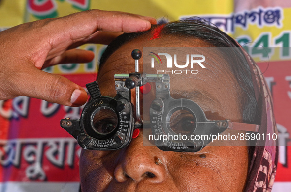 An ophthalmologist checks the eyes of a woman during a free eye-testing camp at Kumirmari village, in the Sundarbans, on July 26, 2022. The...