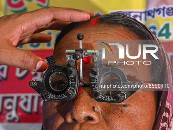 An ophthalmologist checks the eyes of a woman during a free eye-testing camp at Kumirmari village, in the Sundarbans, on July 26, 2022. The...