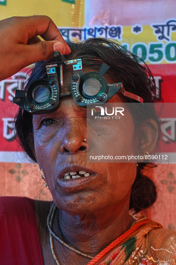 An ophthalmologist checks the eyes of a woman during a free eye-testing camp at Kumirmari village, in the Sundarbans, on July 26, 2022. The...