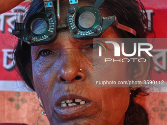 An ophthalmologist checks the eyes of a woman during a free eye-testing camp at Kumirmari village, in the Sundarbans, on July 26, 2022. The...