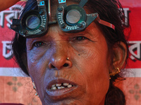 An ophthalmologist checks the eyes of a woman during a free eye-testing camp at Kumirmari village, in the Sundarbans, on July 26, 2022. The...