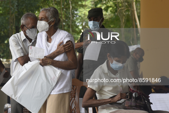 People getting  COVID 19 booster vaccines near amid economic Crisis in Colombo Sri Lanka July 27, 2022
 