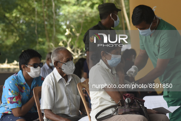 People getting  COVID 19 booster vaccines near amid economic Crisis in Colombo Sri Lanka July 27, 2022
 