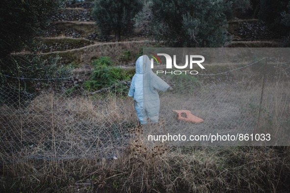 A wet baby’s jumpsuit is hung to dry on a fence along the shoreline on Lesbos, Greece, on September 27, 2015.  