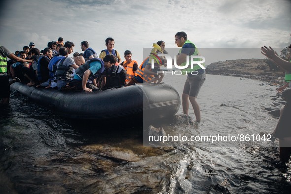 Volunteers welcome migrants from Afghanistan to the island of Lesbos, Greece, on September 27, 2015.  