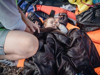 A baby lies on life jackets on the shore of Lesbos, Greece, on September 27, 2015.  (