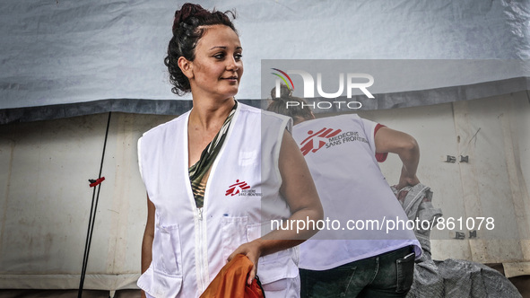 A member of Médecins Sans Frontières (MSF) help migrants in the Greek Island of Kos, on October 21, 2015. Both the local community and large...