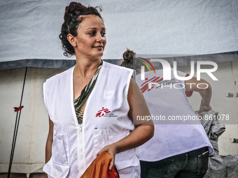 A member of Médecins Sans Frontières (MSF) help migrants in the Greek Island of Kos, on October 21, 2015. Both the local community and large...