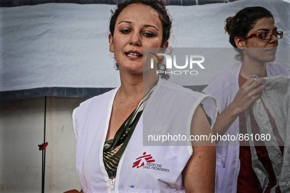 A member of Médecins Sans Frontières (MSF) help migrants in the Greek Island of Kos, on October 21, 2015. Both the local community and large...