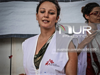 A member of Médecins Sans Frontières (MSF) help migrants in the Greek Island of Kos, on October 21, 2015. Both the local community and large...