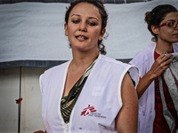 A member of Médecins Sans Frontières (MSF) help migrants in the Greek Island of Kos, on October 21, 2015. Both the local community and large...