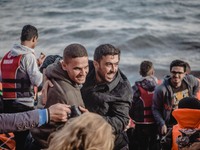 Two men embrace in a hug after a successful crossing from Turkey to Lesbos, Greece, on September 29, 2015.  (