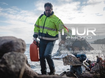 A volunteer helps a child across the rocky shore his boat arrived on in Lesbos, Greece, on September 29, 2015.  (