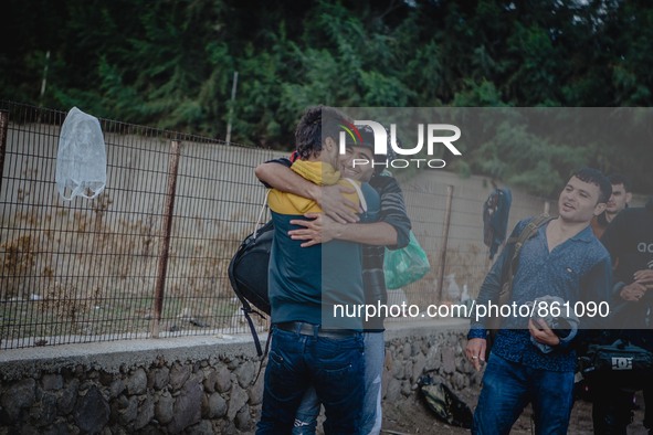 Two men embrace in a hug after a successful crossing from Turkey to Lesbos, Greece, on September 29, 2015.  