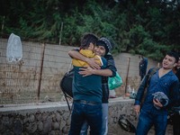 Two men embrace in a hug after a successful crossing from Turkey to Lesbos, Greece, on September 29, 2015.  (