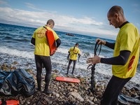 Volunteer lifeguards from Spain prepare to reach a migrant boat that has lost it’s motor and bring it safely to shore, on September 30, 2015...