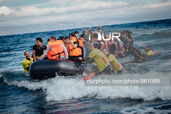 Volunteer lifeguards bring a stranded boat safely to the Greek island of Lesbos, on September 30, 2015.  